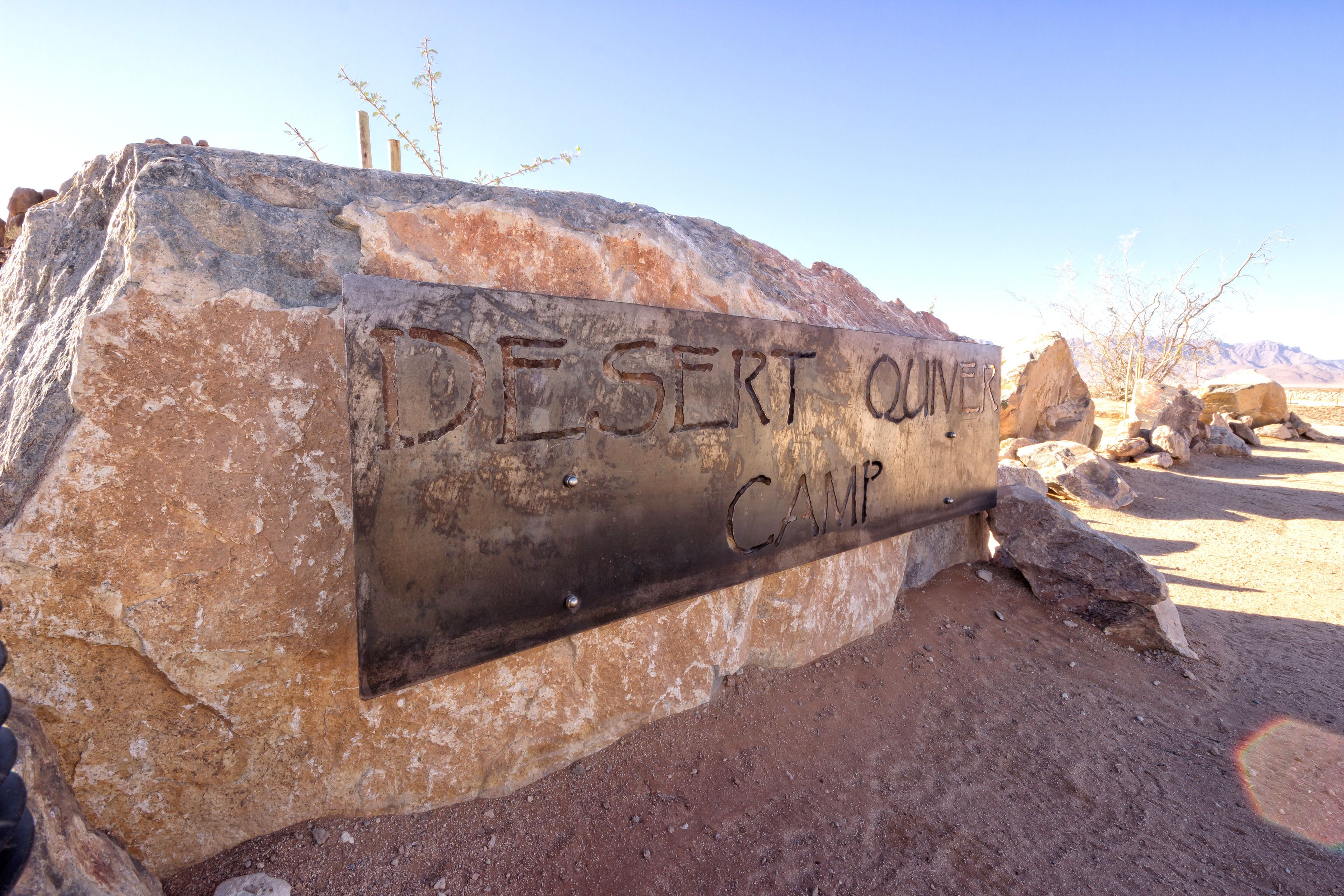 A large rock with the inscription "DESERT QUINTER CAMP".