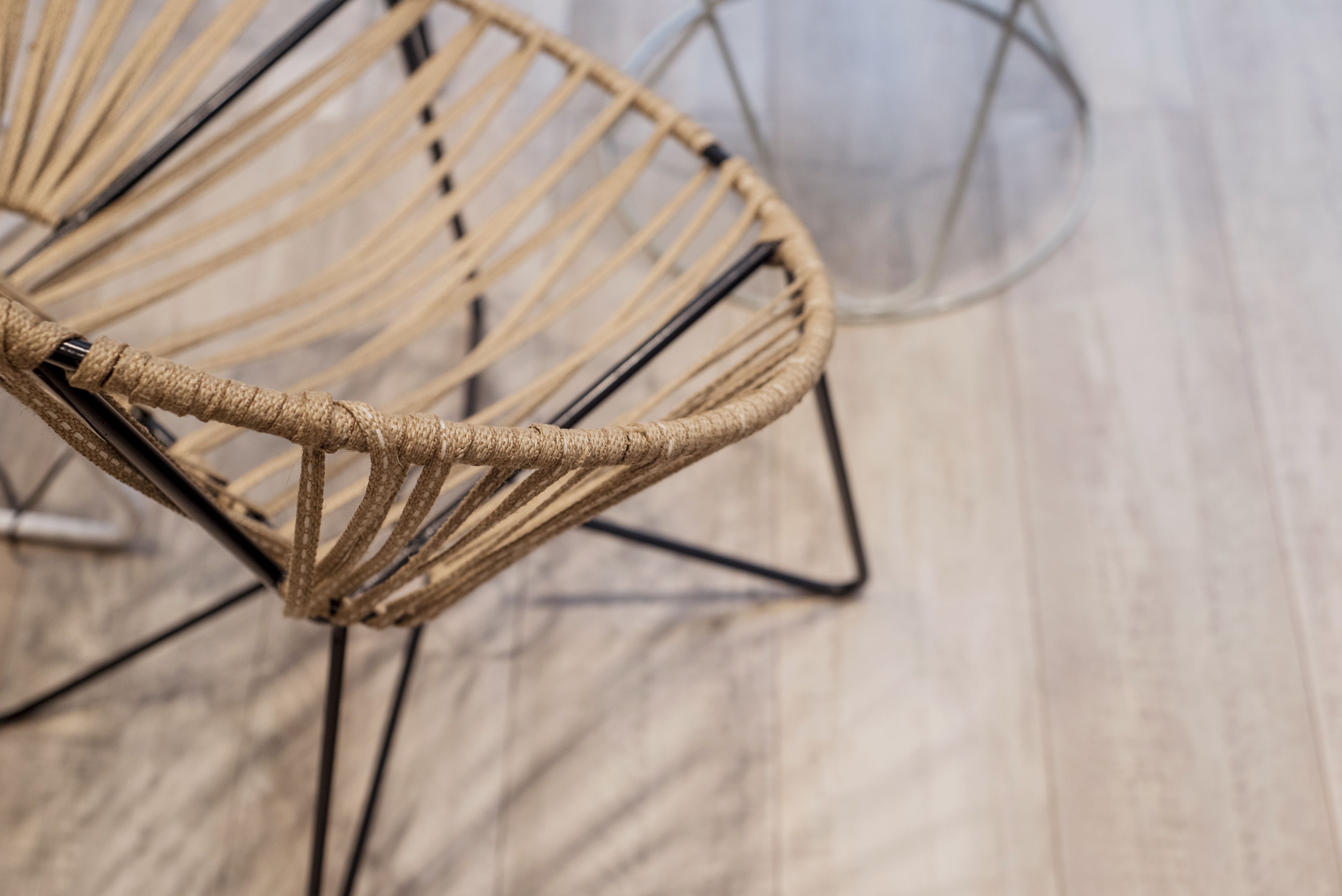 A close-up of a woven chair with a metal frame.