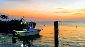 A boat docked at a pier during sunset.