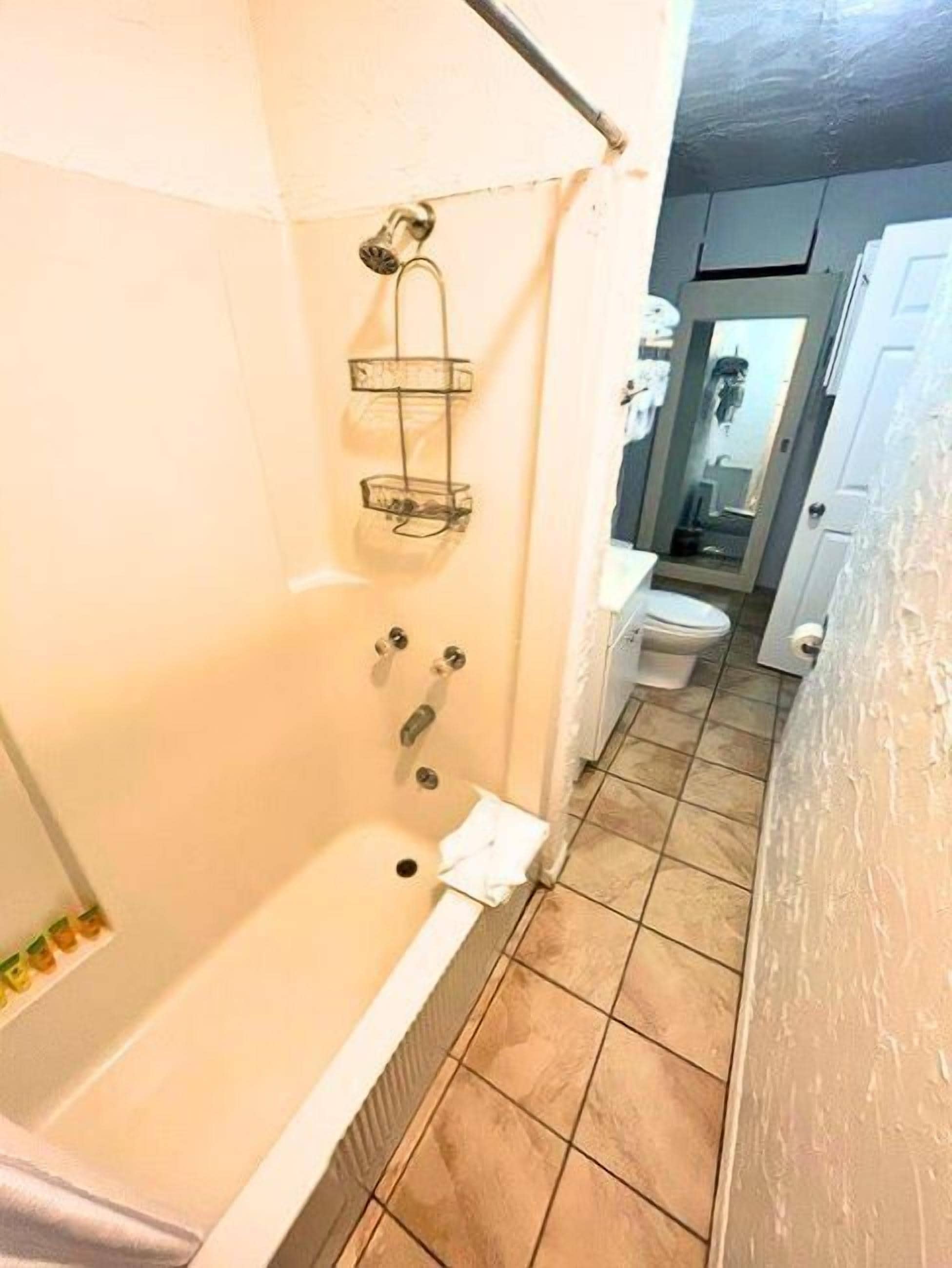 A bathroom with a bathtub, a shower, and a toilet.