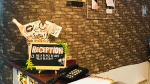 A reception desk with a clock, a 'No Smoking' sign, a bulletin board, and a 'Reception' sign. - Suria Beach Resort (Pangkor Island)
