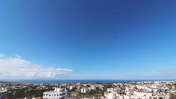 A coastal cityscape with a clear blue sky.
