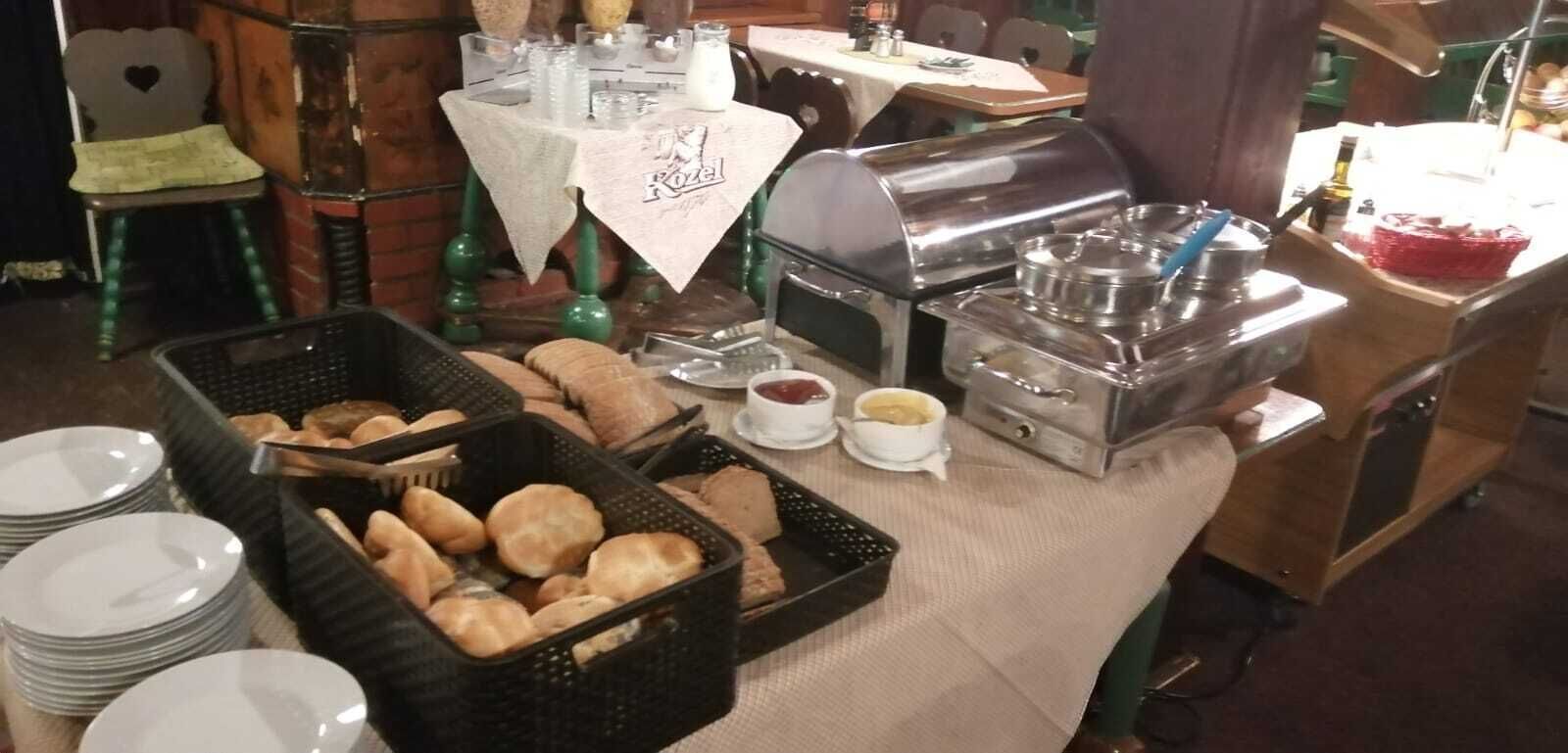 A buffet setup with bread, butter, and condiments.