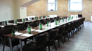 A conference room with a long table, chairs, and water bottles.