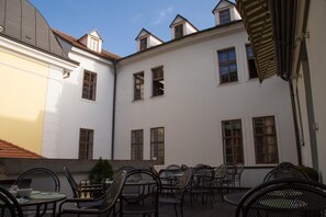 A courtyard with outdoor seating and multiple windows.