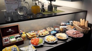 Un bufé de desayuno con diversas opciones de comida y bebidas.