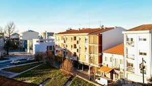 A residential area with multi-story buildings, a parking lot, and a clear sky. - Santo Thyrso Hotel (Santo Tirso)