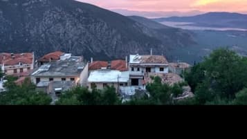 A mountainous landscape with a village featuring traditional architecture and terraced fields.