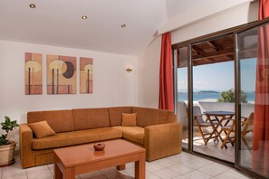 Suite, Sea View | Living room | Flat-screen TV