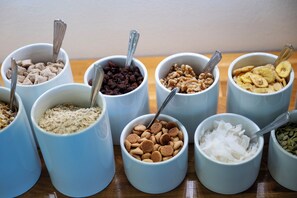 Multiple bowls of various food items on a wooden surface. - Port Hotel (Karlshamn)