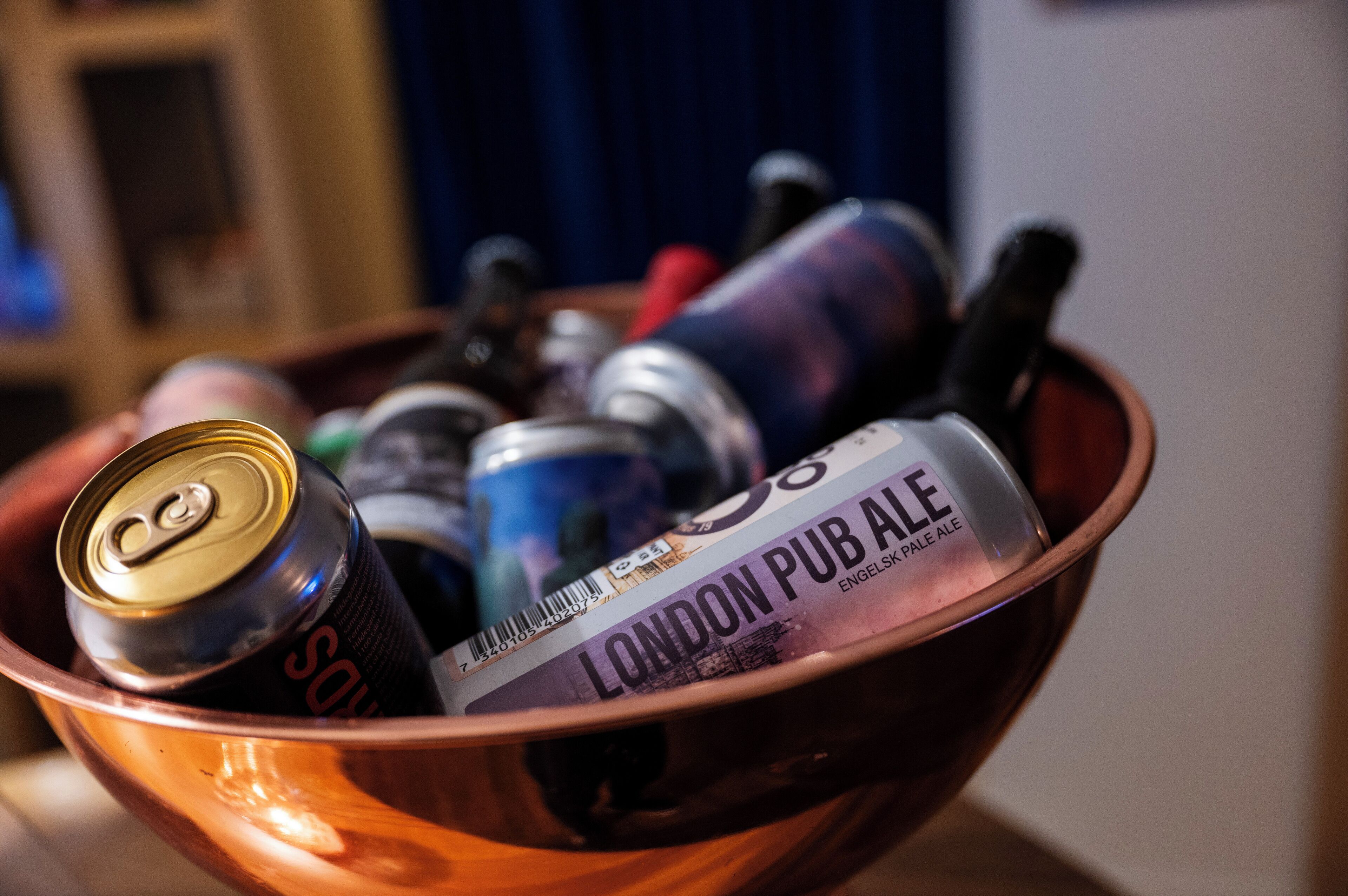 Un cuenco con una lata de Sol, una botella de London Pub Ale y otros artículos.