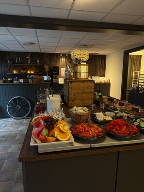A buffet with various food items including fruits, cheeses, and meats. - First Camp Moraparken (Mora)