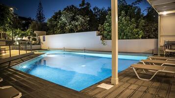 Seasonal outdoor pool, open 9:00 AM to 8:00 PM, pool umbrellas