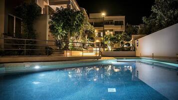 Seasonal outdoor pool, open 9:00 AM to 8:00 PM, pool umbrellas