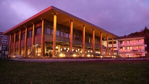 A modern building with a flat roof, large windows, and a central open space.