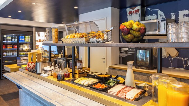 A buffet with various food items and beverages.