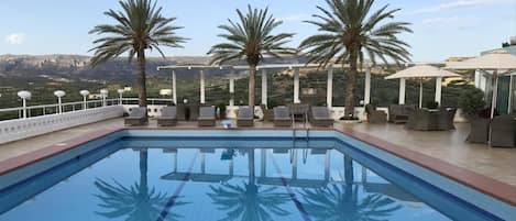 Seasonal outdoor pool, pool umbrellas, pool loungers