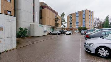 A hotel with a modern design, featuring a large cylindrical structure and a multi-story building with balconies.