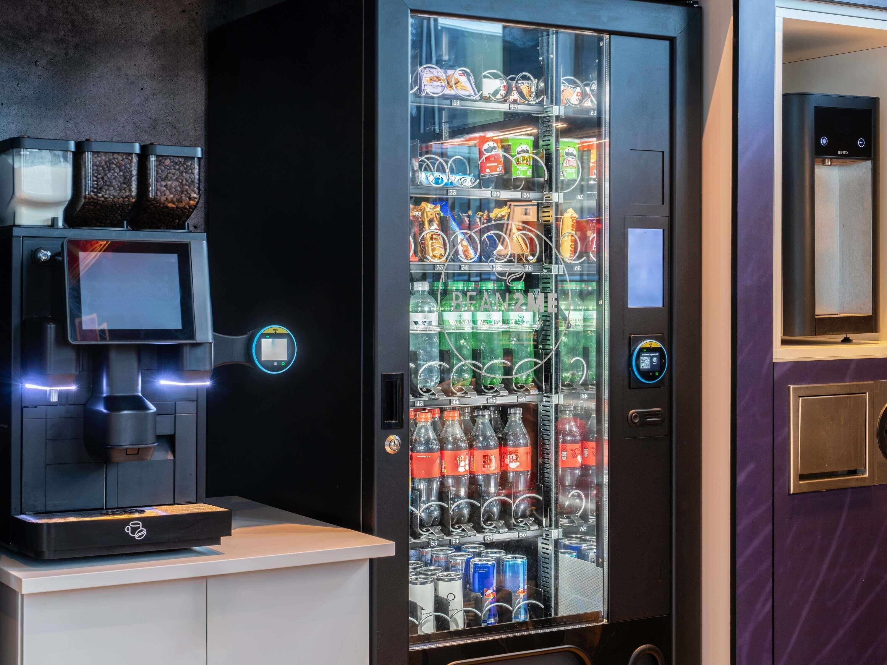 A beverage vending machine with a coffee maker and a digital display.