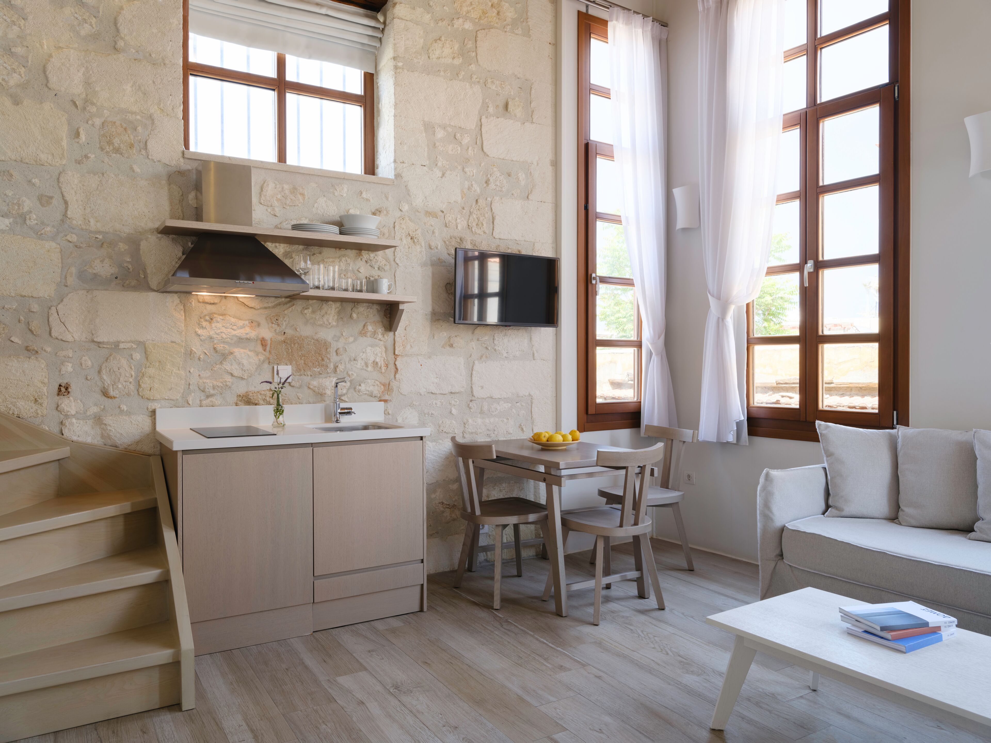 A compact living space with a kitchenette, a dining area, and a seating area.