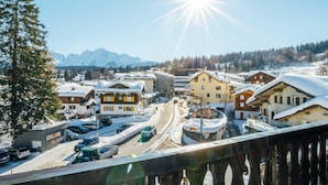 A snowy mountain town with buildings and a road.