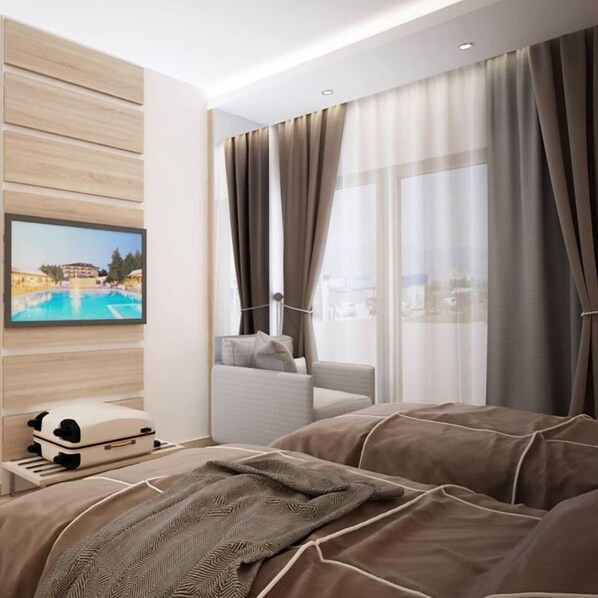 Una habitación de hotel moderna con una cama grande, un televisor montado en la pared y una ventana con cortinas.