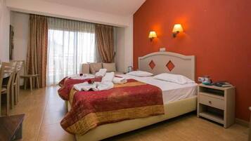 A hotel room with a bed, bedside table, and a chair.