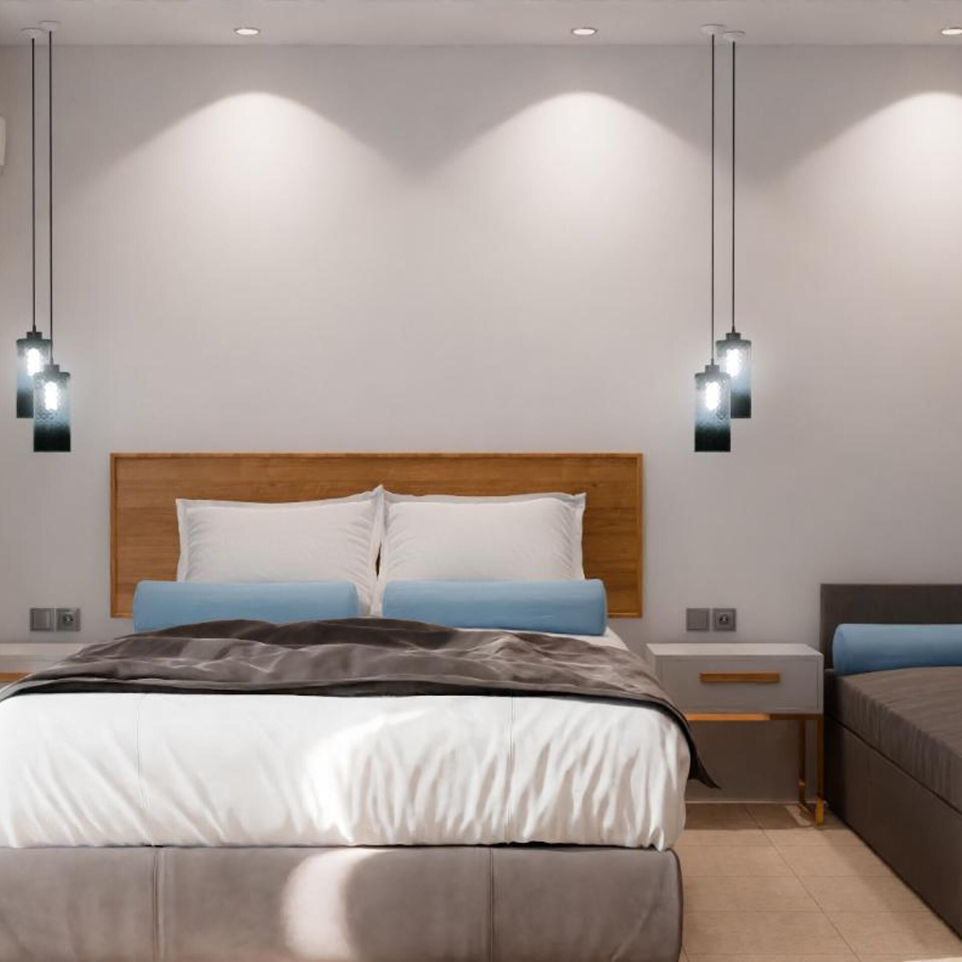 A modern bedroom with a large bed, bedside tables, and pendant lighting.