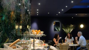 A breakfast buffet with various food items and a decorative wall. - Hotel Eastside (St. Gallen)