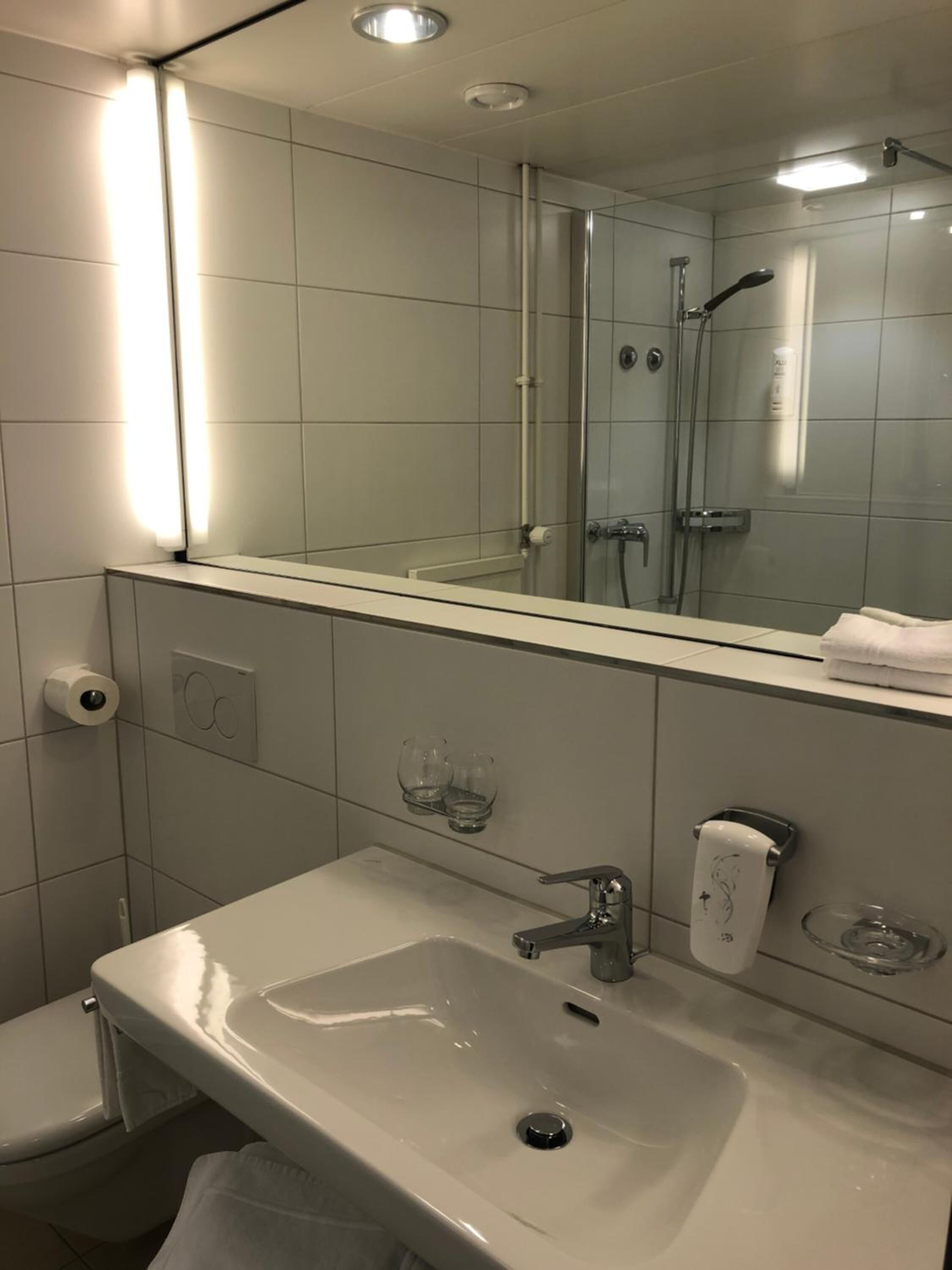 superior single room | bathroom | hair dryer, slippers, towels, soap
