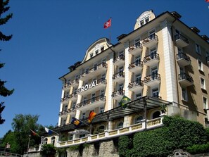A multi-story hotel with balconies and a prominent "ROYAL" sign. - Hotel Royal Lucerne (Lucerne)