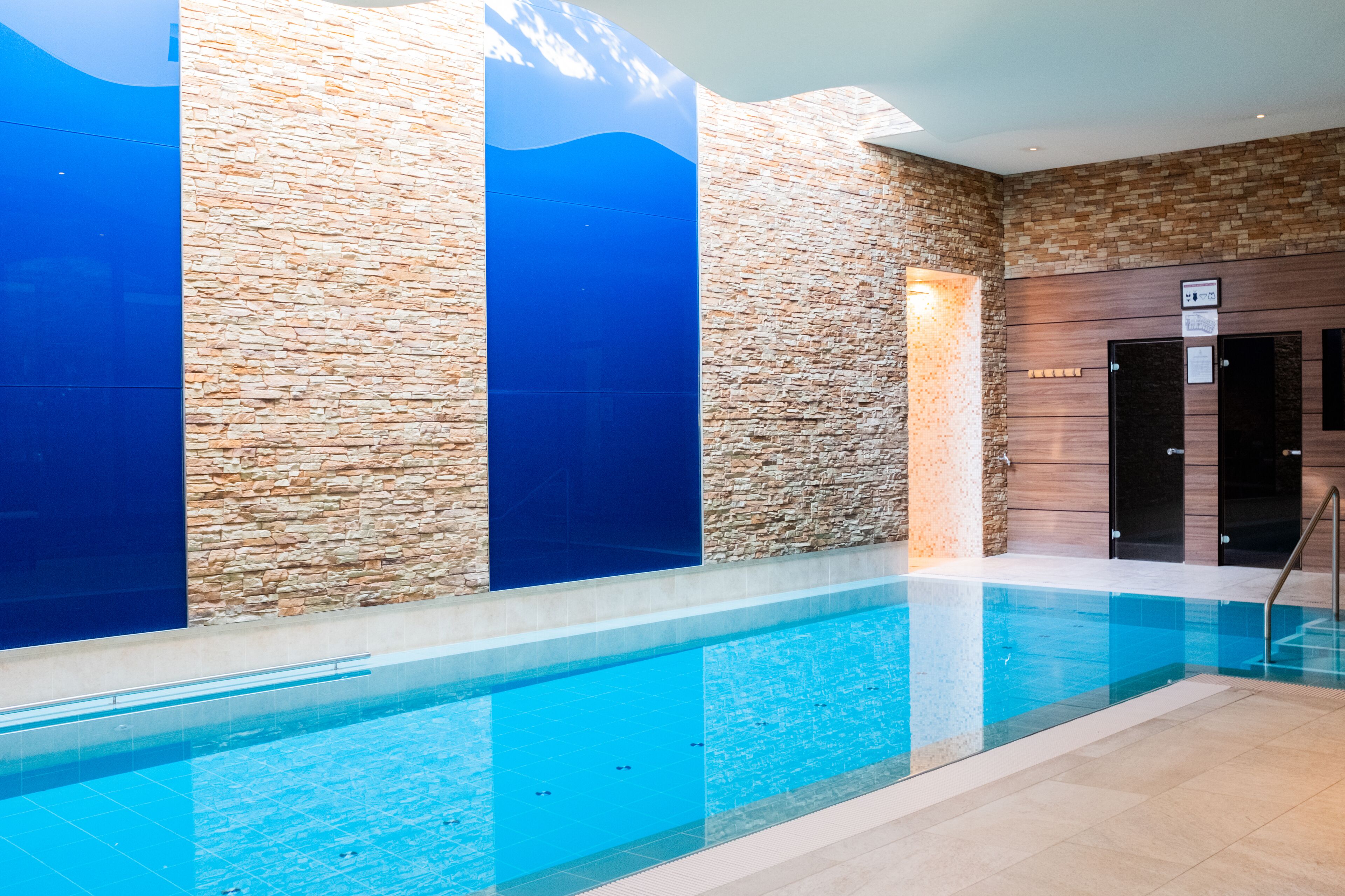 indoor pool, pool umbrellas, pool loungers