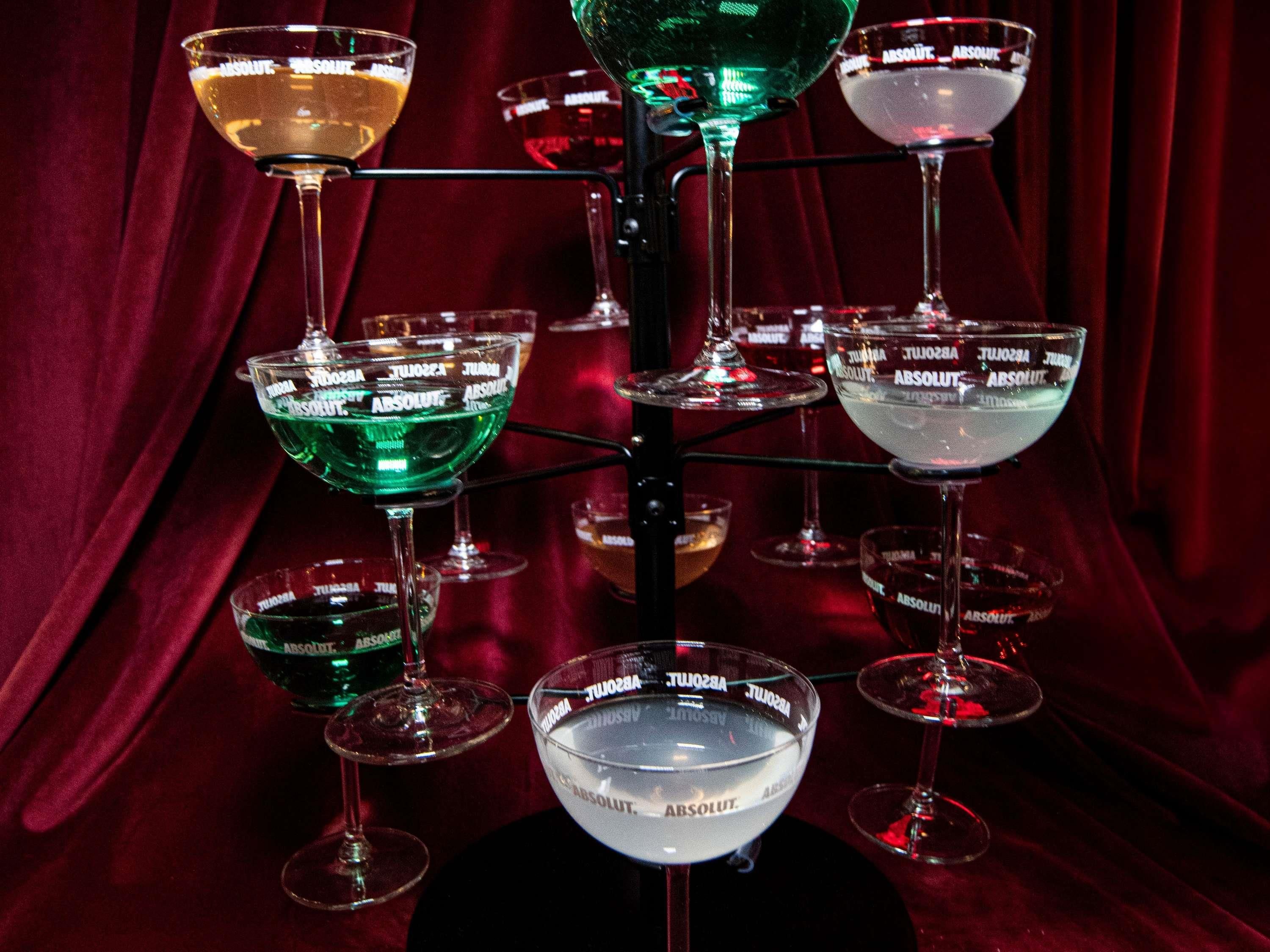 A collection of glasses on a stand with 'ABSOLUT' branding.