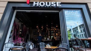Das Hotel MAD HOUSE, mit Bar und Restaurant im Erdgeschoss, zeigt eine Außenansicht mit Außenbereich und Blick auf die Stadt.