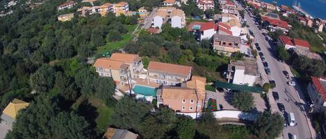 An aerial view of a coastal town with buildings, roads, and a beach.