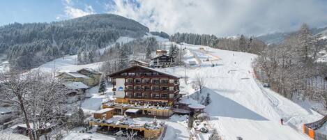 A ski resort with a large lodge, ski slopes, and snow-covered trees.