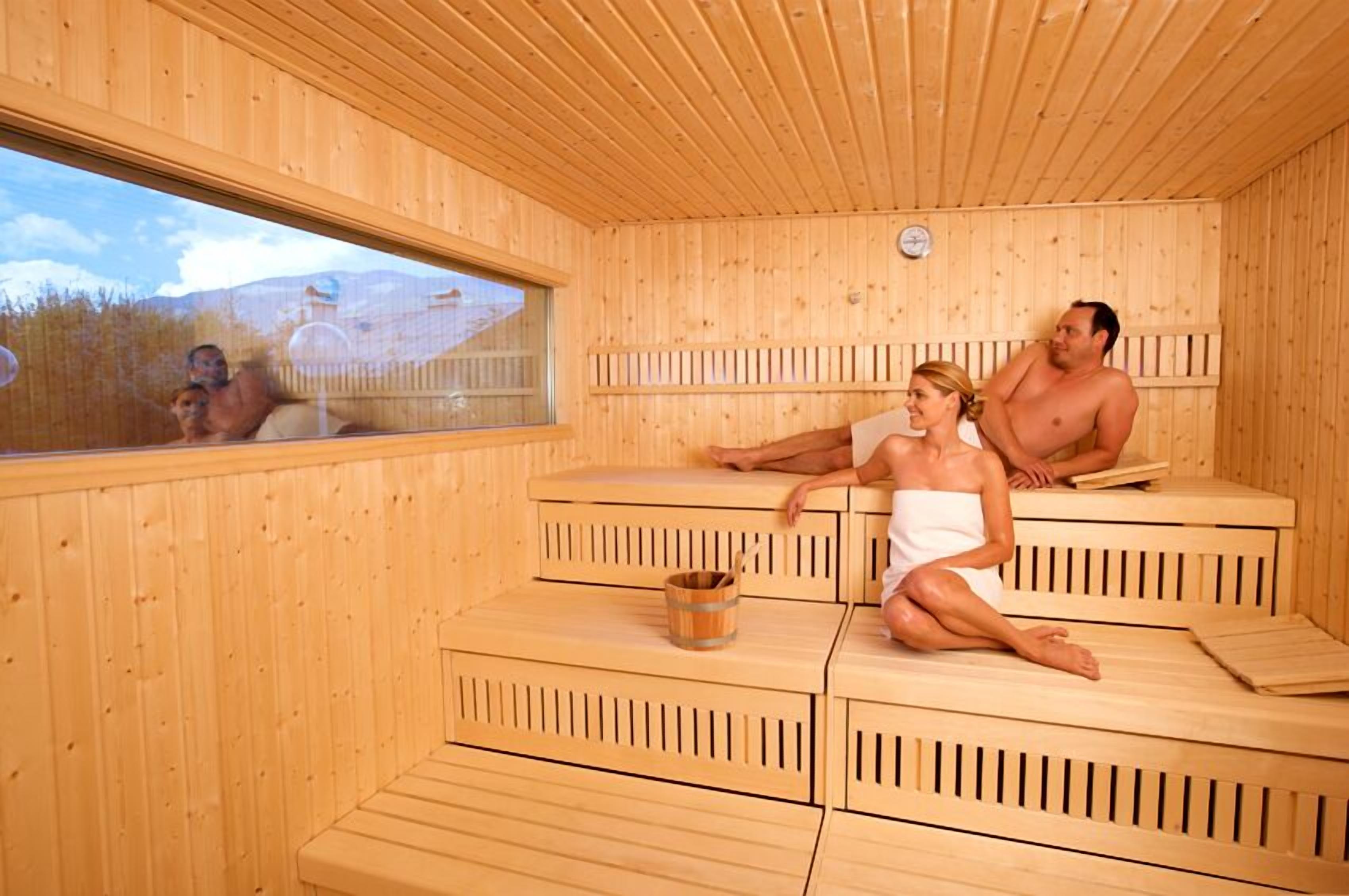 A sauna with wooden benches and a window.