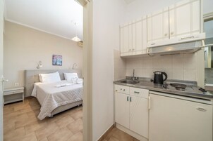 Un dormitorio con cama, mesita de noche y un cuadro en la pared.