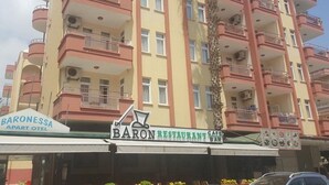 Een meerlaags gebouw met balkons, een bar en een restaurant.