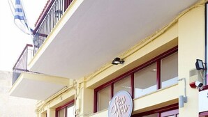 A building with a sign reading "Sella" and a balcony with a railing. - Aegean Sea Rooms (Chios City)