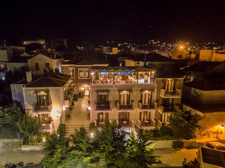A multi-story hotel with a central courtyard, balconies, and a rooftop terrace.