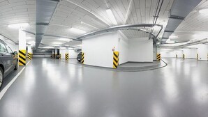 A modern underground parking garage with a single car parked in a designated space. - B&B Hotel Torun (Torun)