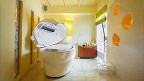 A modern bathroom with a large white bathtub, a wooden vanity, and a wall-mounted heater. - Geovita Krynica Zdroj (Krynica-Zdroj)