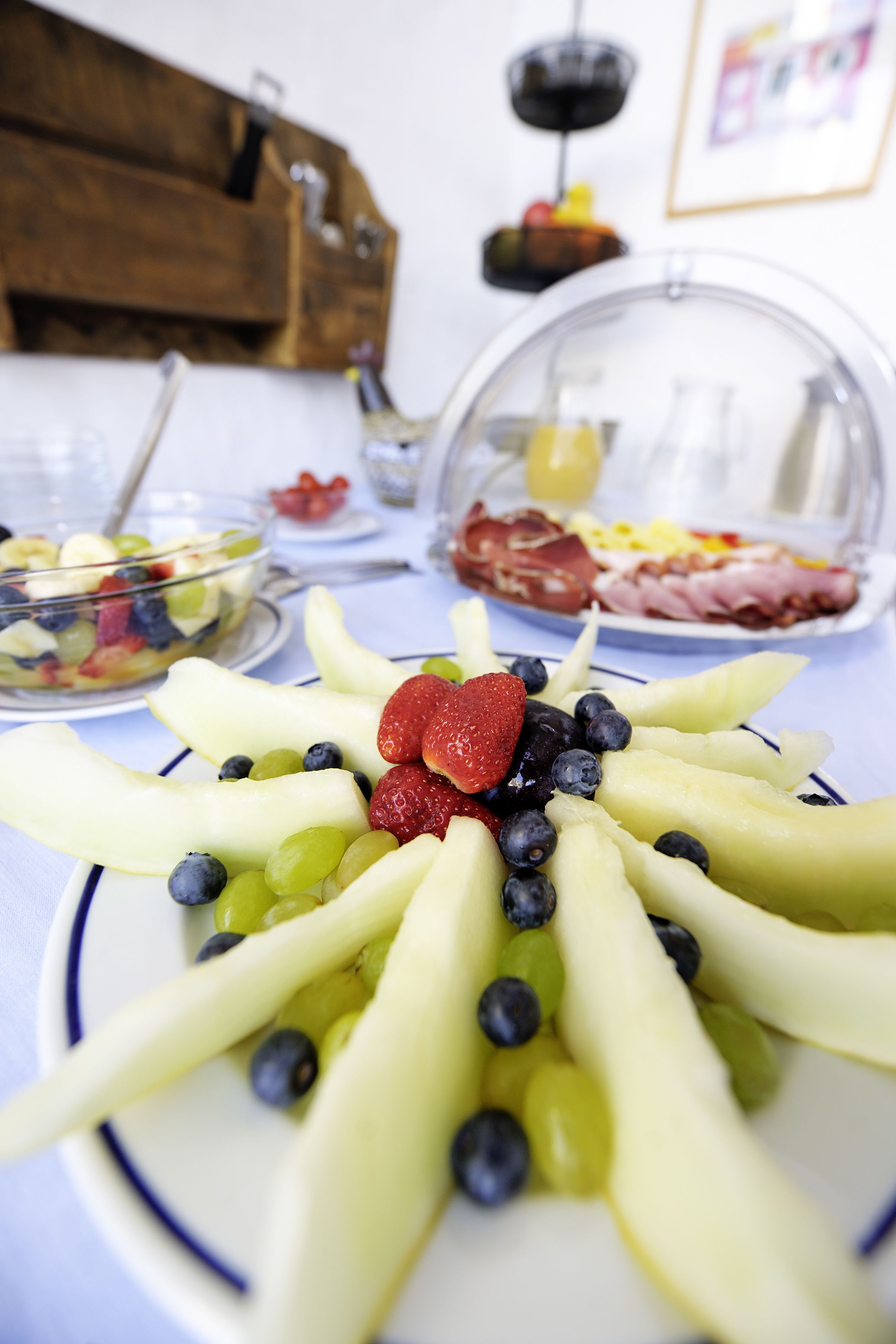 A fruit platter with strawberries and blueberries on a white plate.