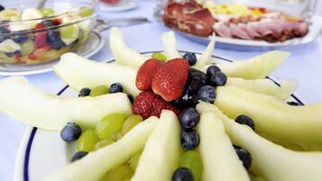 A fruit platter with strawberries and blueberries on a white plate.
