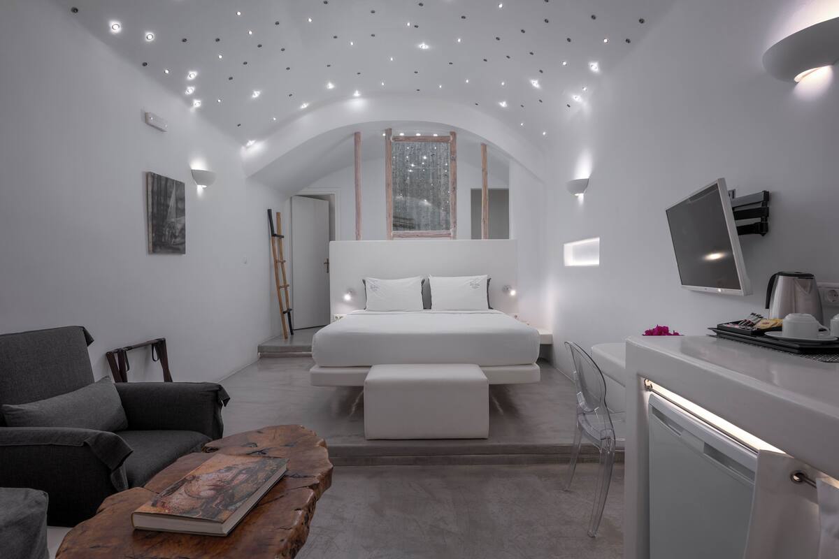 A modern bedroom with a bed, a desk, and a chair.