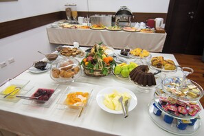 A buffet table with various food items and a coffee station. - Kotoni (Tirana)