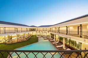 A hotel with a central swimming pool, outdoor seating areas, and multiple balconies. - Mola Cunda Hotel (Ayvalik)