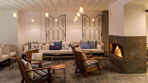 A modern living room with a fireplace, comfortable seating, and pendant lighting. - Mola Cunda Hotel (Ayvalik)