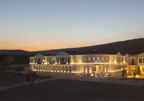 A modern hotel with a prominent "MOLA" sign, featuring a symmetrical facade with evenly spaced windows and a central entrance. - Mola Cunda Hotel (Ayvalik)